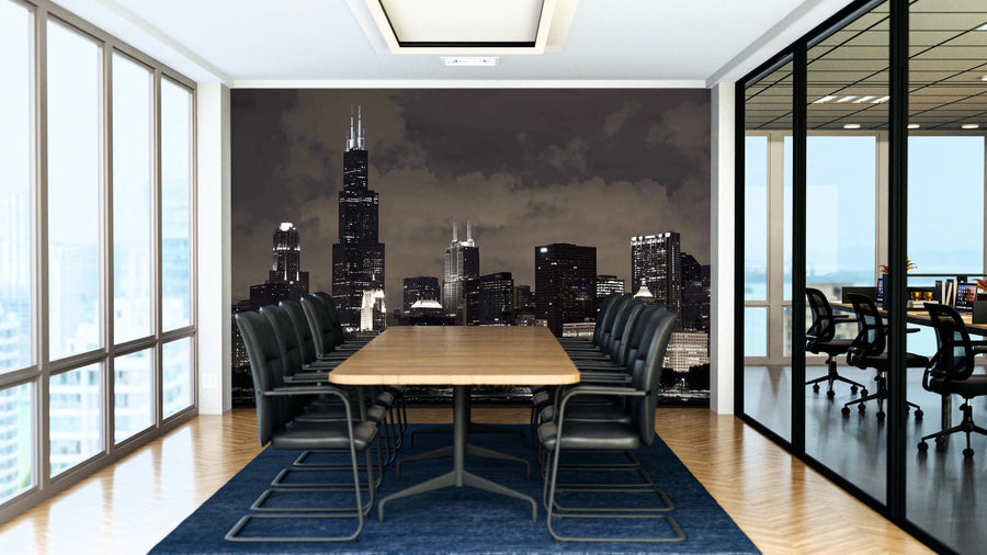A modern conference room features a long wooden table, black chairs, and the Chicago Architecture at Night Wall Mural. Floor-to-ceiling windows and glass walls open to another office area. Wood floors and a blue rug finish the space.