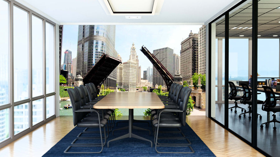 A modern conference room with a long wooden table, black chairs, and glass walls features the Chicago River Bridge Wall Mural, showcasing Chicago’s raised bridges and skyscrapers. The adjacent office is visible through the glass partition.