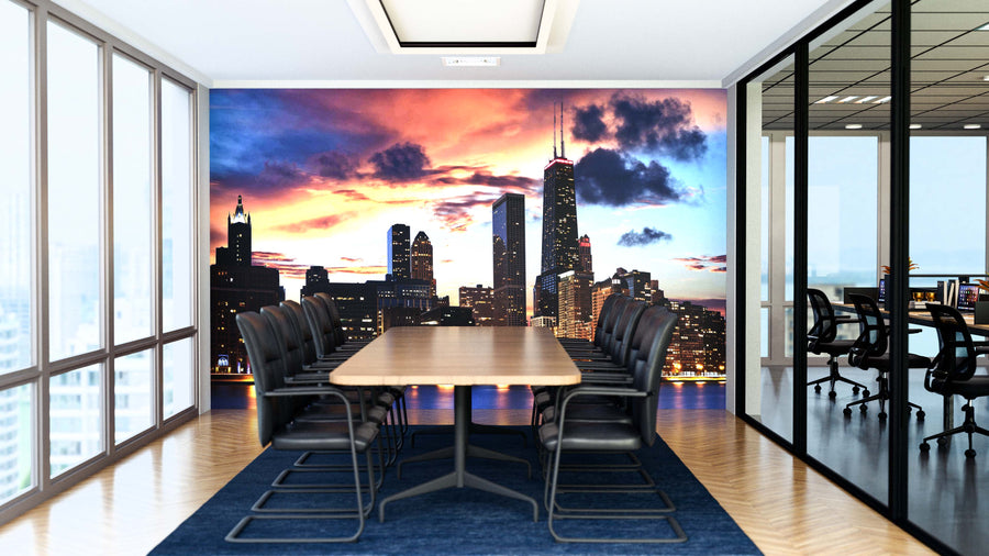 A modern conference room with a long wooden table and black chairs features a striking Chicago Skyline at Dusk Wall Mural on the back wall, while glass walls reveal another meeting room and city views.