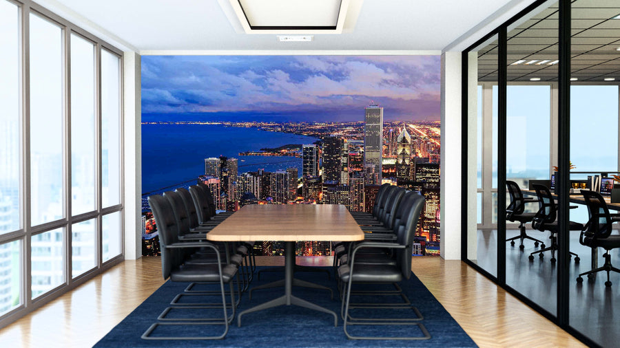A modern conference room with a long wooden table, black chairs, and glass walls. The back wall showcases the Chicago Skyline Dusk Wall Mural—a matte, canvas-textured peel and stick mural depicting a city skyline at dusk beside the coast.