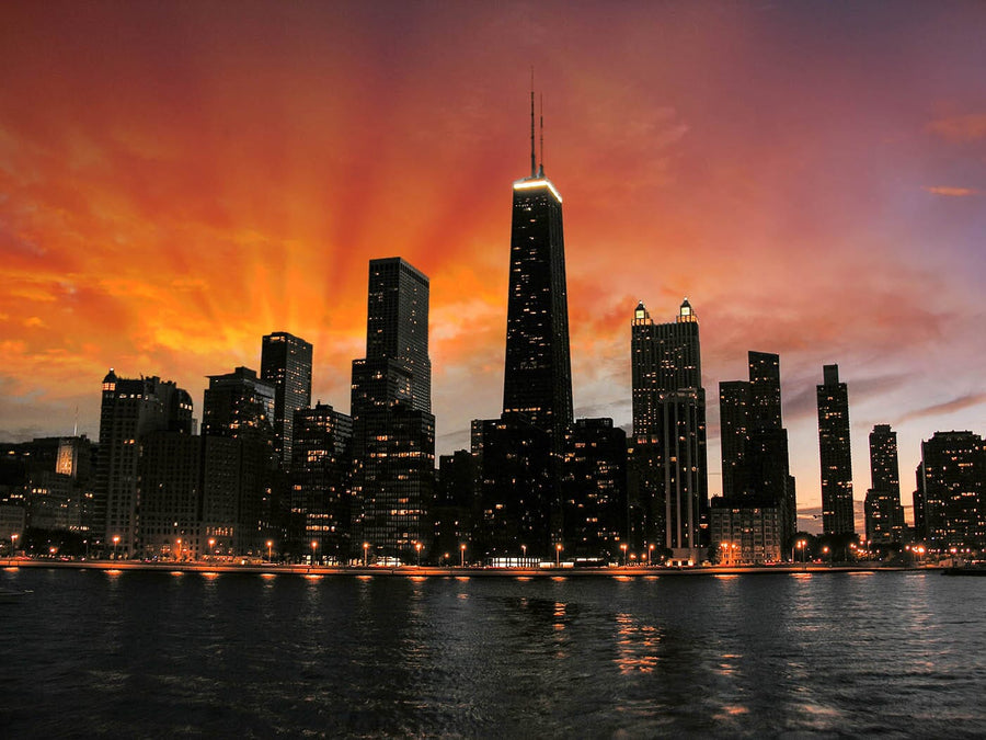 A modern conference room with a long wooden table, black chairs, floor-to-ceiling windows, and a striking Chicago Skyscrapers Silhouette Wall Mural. Glass walls reveal another office space.