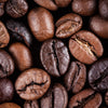 Close-up of roasted coffee beans in varying shades of brown fills the frame like Coffee 12 Wall Mural, with visible cracks and textures highlighting their glossy, slightly oily surfaces, capturing the rich essence akin to a detailed peel and stick design.