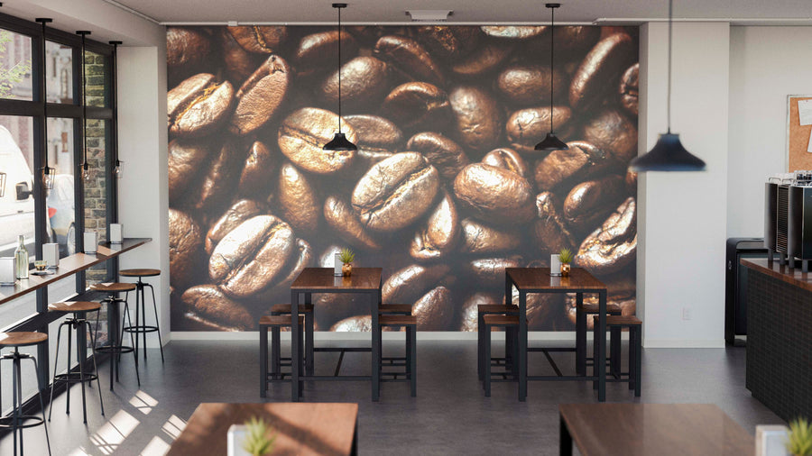 Bright café with wooden tables, stools, and pendant lights features the Arabica Coffee Beans Wall Mural as a striking focal point. Tall windows on the left let in natural light for a warm, inviting ambiance.