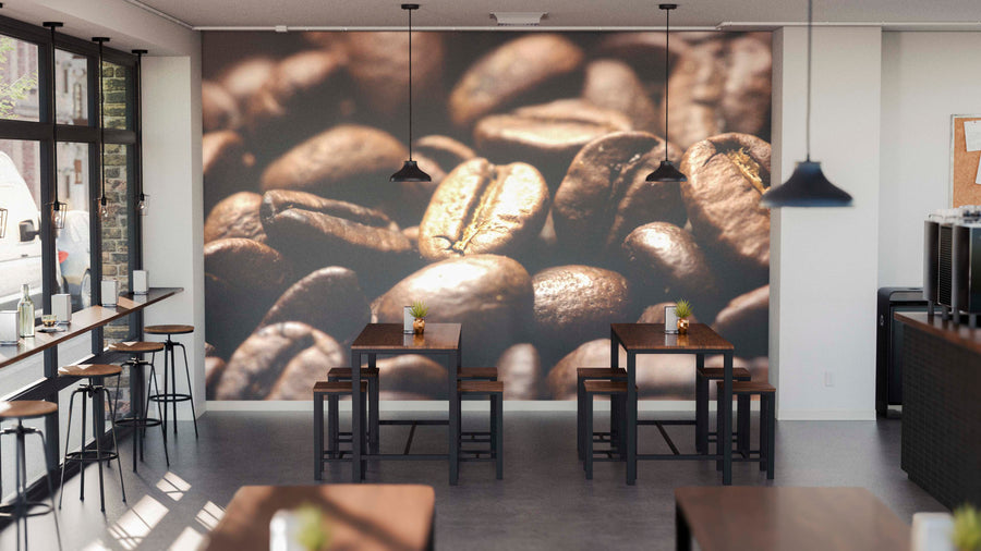 A modern cafe with high tables, stools, industrial lighting, and bar seats by large windows features the Aromatic Coffee Beans Wall Mural on the back wall, adding cozy warmth and style with its rich brown coffee bean design.