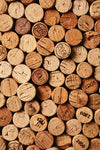 The Collection of Wine Corks Wall Mural features an earthy, rustic pattern with vintage cork markings and shades ranging from light tan to dark brown, making it an ideal inspiration for removable wallpaper or a peel-and-stick wall mural.