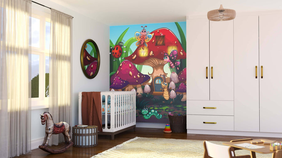 A bright nursery features the Colorful Critter Cottage Wall Mural of a whimsical mushroom house with cartoon insects behind the crib, plus a wardrobe, changing basket, rocking horse, rainbow stacker, and sunlit curtains at the window.