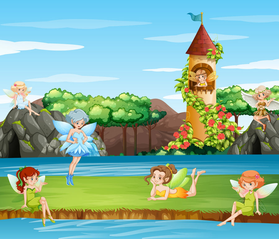Five fairies in bright dresses relax on grass by a river—two lie down, one stands, and two sit on rocks. Behind them rises a tall flower-covered tower. The Nursery 16 Wall Mural brings this magical scene to any room.