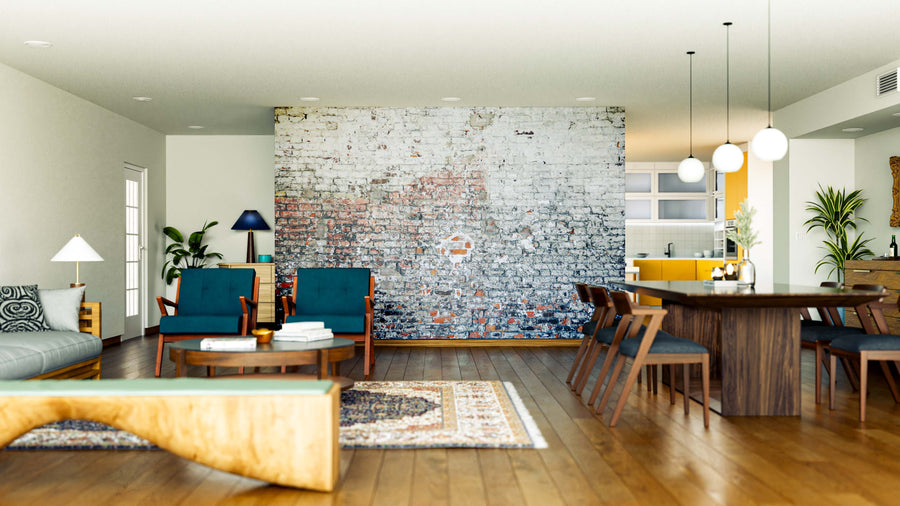 A modern open living and dining area features a Faded Brick Texture Wall Mural, wooden floors, blue armchairs, a gray sofa, and a dark wood dining table. Pendant lights and plants add warmth and color to the space.