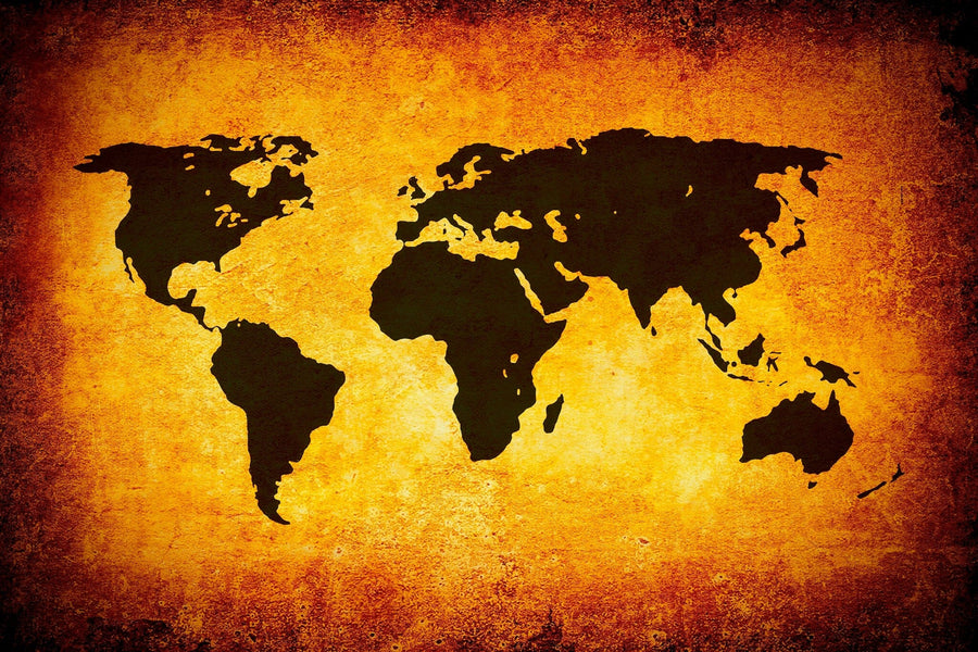 The Map 17 Wall Mural features a black silhouette world map centered on a textured backdrop in orange, yellow, and brown tones, creating an antique parchment-like effect. The map has no labels or country borders.