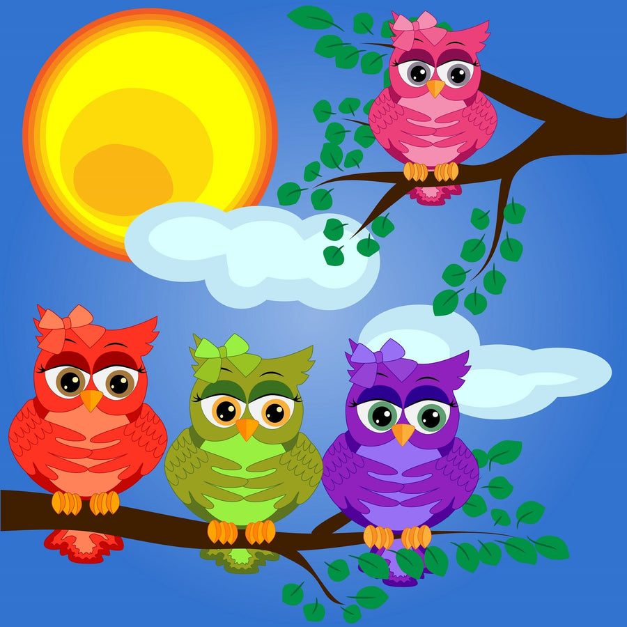 A nursery featuring a crib, wicker hamper, toys, and the Four Vibrant Owls Wall Mural showing cartoon owls on branches against a blue sky. Light pours in from a window; a round mirror and pendant light finish the look.
