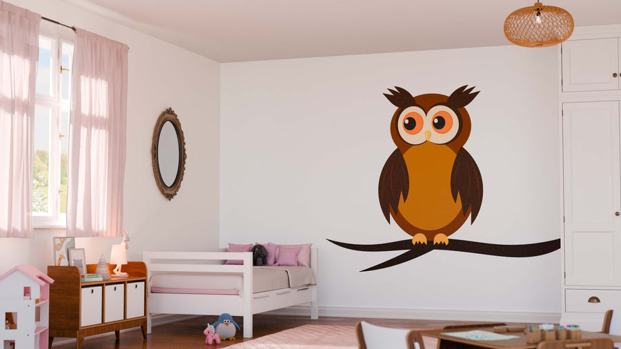 A cozy, sunlit child's bedroom features pink curtains, a white bed with pink pillows, plush toys, and a toy house. The focal point is the large Owl Wall Mural—a cartoon peel and stick design—while a wicker light fixture hangs overhead.