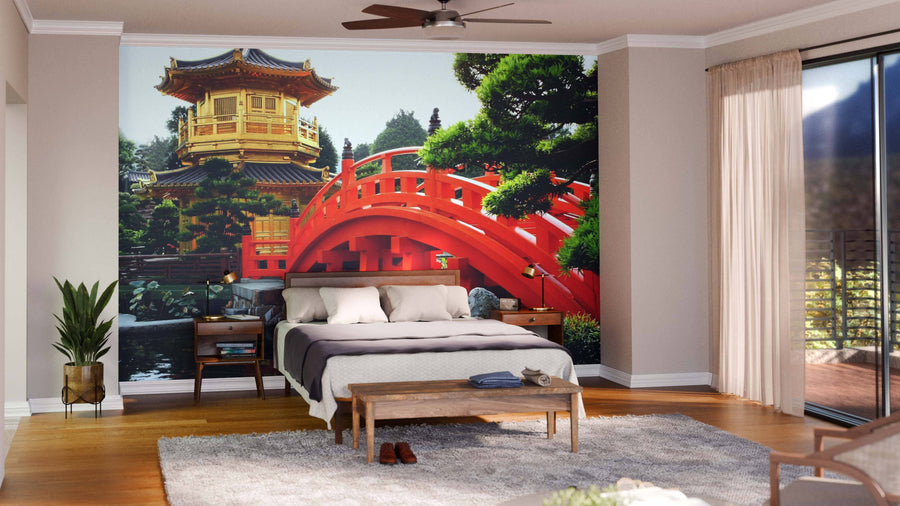 A cozy bedroom features the Golden Pavilion of Chi Lin Nunnery Wall Mural with a red arched bridge and golden pagoda, adding an Asian-inspired focal point. The room includes a bed, benches, plants, large windows, and wooden floors.