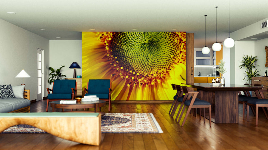 A modern open living and dining area features wood floors, stylish furniture, and a striking Golden Swirl Wall Mural. Blue chairs, a wooden dining table, pendant lights, and green plants complete this vibrant, inviting space.
