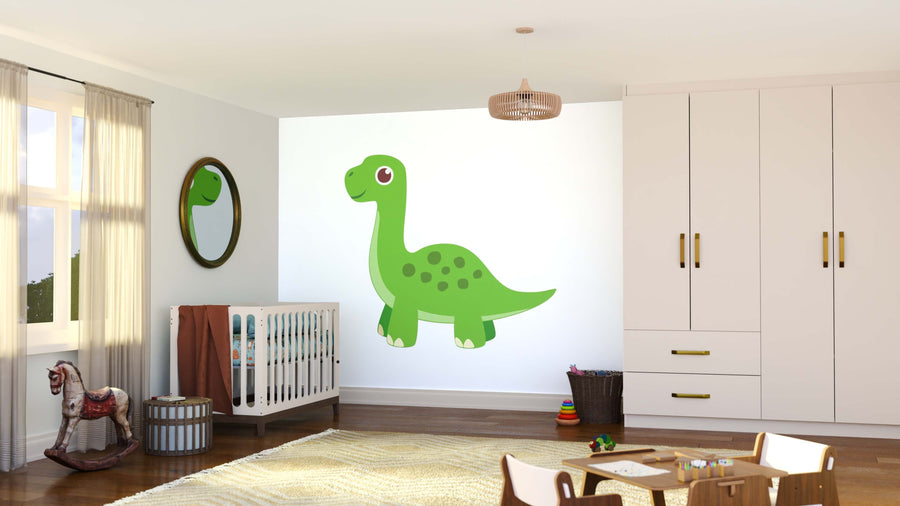A bright, tidy nursery features a Green Dino Wall Mural on a white wall, a crib with a brown blanket, circular mirror, woven baskets, stacked rings, and white cabinets with gold handles. Sunlight pours in through the window.