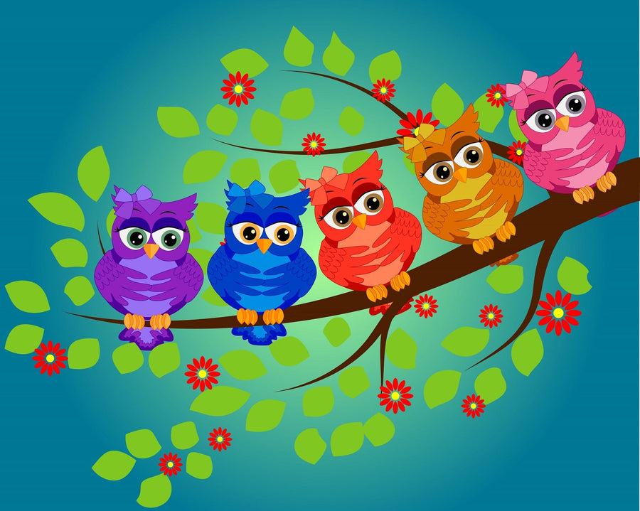 A nursery features a white crib against a blue wall decorated with the Group of Colorful Owls Wall Mural, showing five cartoon owls on a branch. The room also includes a white dresser, houseplants, wooden floor, shelves with decor, and streaming sunlight.