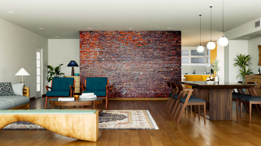 A modern open-plan living and dining area features wood floors, teal and wood furniture, pendant lights, a patterned rug, bright natural light, contemporary decor, and a brick accent wall enhanced by the Grunge Brick Wall Mural.