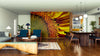Modern open-plan living/dining room with wood floors, mid-century furniture, and the Heart of the Sunflower Wall Mural as a stunning focal point. Plants, pendant lights, and a rug complete the space with warmth and inviting style.