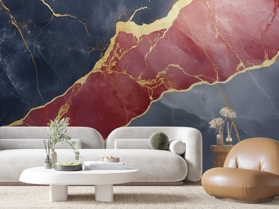 Create a modern living room with the bold geometric design of the Imperial Marble Wall Mural, showcasing deep blue and red marble textures with gold veining. Complement it with a white curved sofa, a rounded white coffee table with books and plants, a brown chair, and a small wooden table.