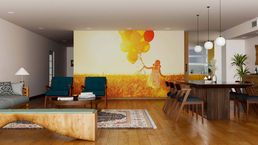 A modern living-dining room with wooden floors, teal chairs, a rug, and dining table features the Carefree Childhood Wall Mural, depicting a child with colorful balloons in a sunlit field for added warmth and playful charm.