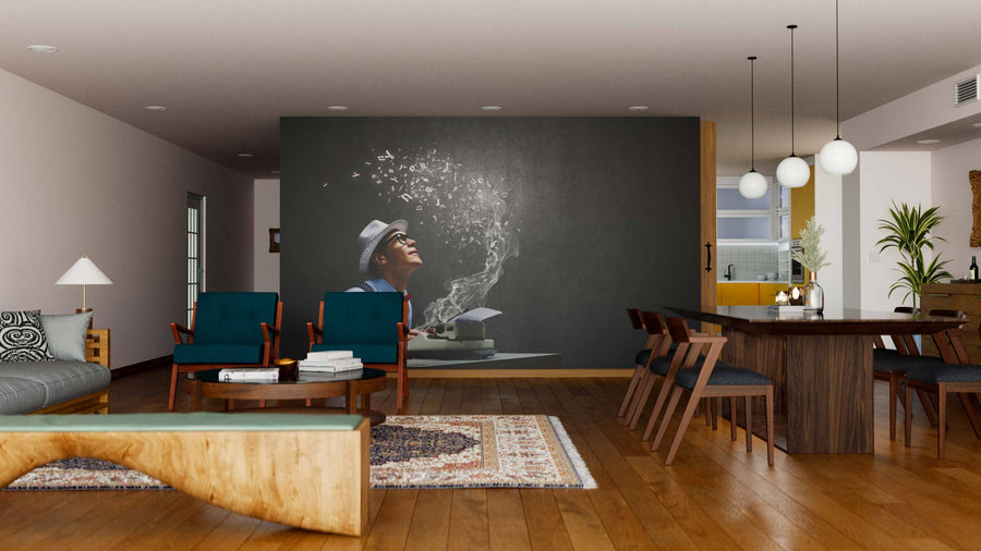 A modern living-dining room with wood floors, teal chairs, a sculpted coffee table, and dining table for six is highlighted by the Creative Inspiration Wall Mural depicting a smiling person in glasses with magical symbols rising from an open book.