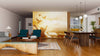 A modern open-plan living and dining room with wooden floors features the Embrace the Light Wall Mural, depicting birds flying beside a person with raised arms against a golden sky. Teal armchairs and a gray sofa complete the look.