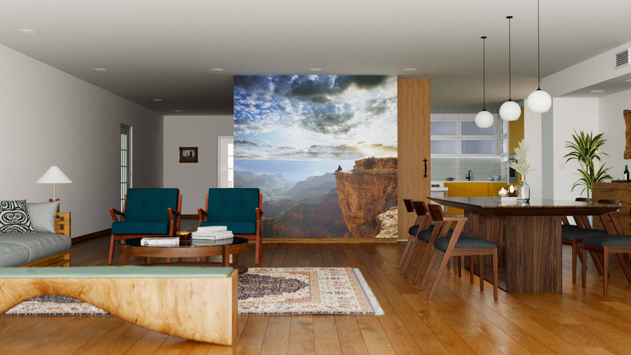 Modern open-plan living and dining room with wood floors, teal chairs, a large wooden dining table, and a striking Grand Canyon Wall Mural peel and stick feature that adds depth and natural beauty to the contemporary space.