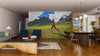 A modern living-dining room with wooden floors, teal chairs, and a large dining table features the Nature Run Wall Mural, showcasing a person running in green mountains under a cloudy sky and bringing scenic outdoor vibes indoors.
