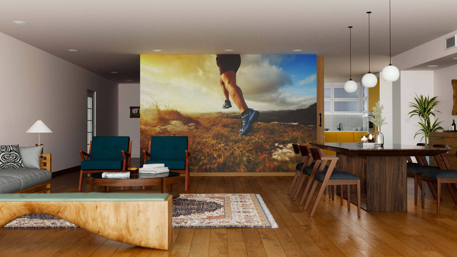 A modern living and dining area with wooden floors, contemporary furniture, and the Running Man Wall Mural depicting a person running outdoors at sunset on the back wall, adding dynamic energy to the stylish space.
