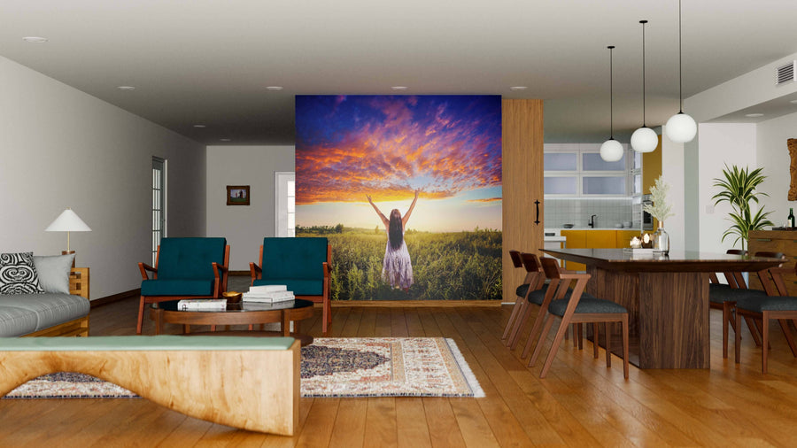Modern open-plan living and dining area with wooden floors, teal and wood furniture, and a custom 'Standing on a Field Wall Mural.' Contemporary lighting and kitchen are visible in the background.