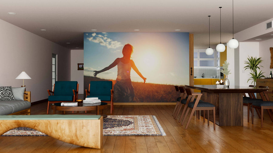 A spacious, modern living-dining room with wooden floors and mid-century furniture features the Sunlit Freedom Wall Mural. Warm lighting, rugs, and décor create a cozy, inviting atmosphere.
