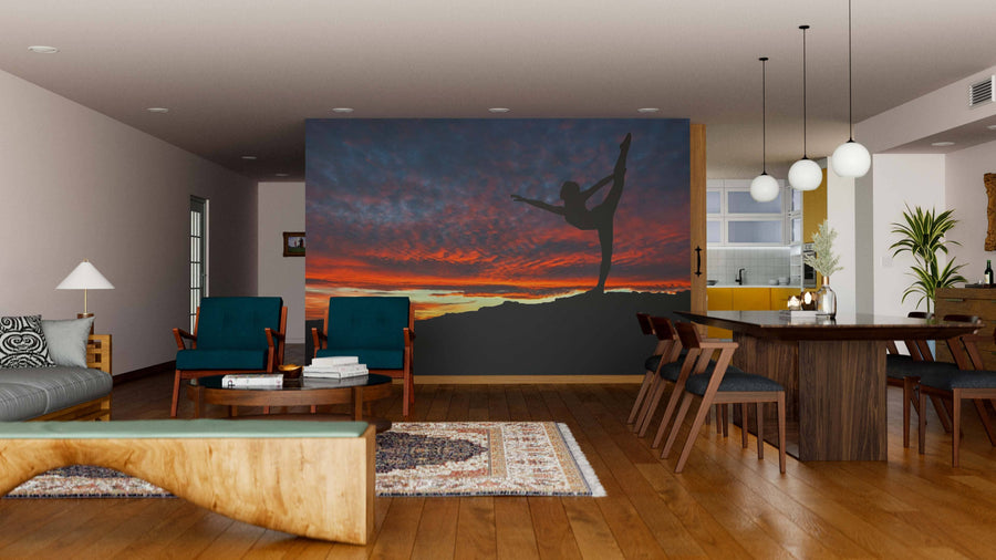 A modern living-dining room with wooden floors, mid-century furniture, and a large Woman Stretching Wall Mural; pendant lights brighten the dining table, while a cozy rug offers comfort underfoot.