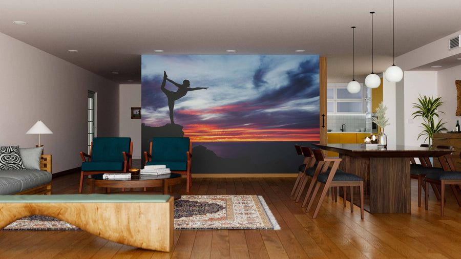 Modern living and dining area with wooden floors, contemporary furniture, and a Yoga Wall Mural featuring a yoga silhouette against a sunset sky. Warm ambient lighting creates a cozy, inviting atmosphere.