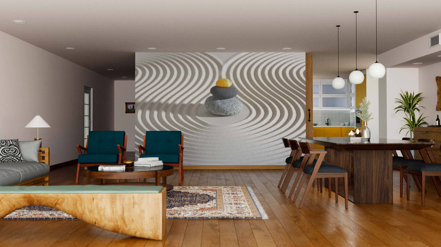 A modern open-plan living and dining room with wood floors, teal chairs, and pendant lights features the Japan Zen Garden Wall Mural of stacked stones on raked sand, creating a tranquil zen-like focal point.