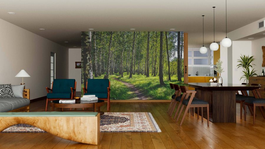 A modern living-dining area with wood floors, stylish furniture, and neutral walls features the Birch Tree Forest In The Sun Wall Mural, adding a nature-inspired focal point with its sunlit forest and path.