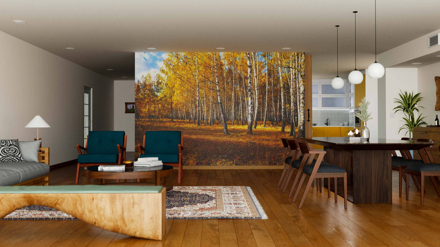 A modern living and dining room with wood floors, teal and wooden furniture, pendant lights, and a large Birch Tree Grove Wall Mural behind the dining area. The space feels open, inviting, and perfect for unique wall art.