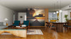 A modern open-plan living and dining area features wood floors, teal armchairs, a wooden table, and the Boardwalk on the Beach Wall Mural. The kitchen with striking yellow cabinets is visible in the background.