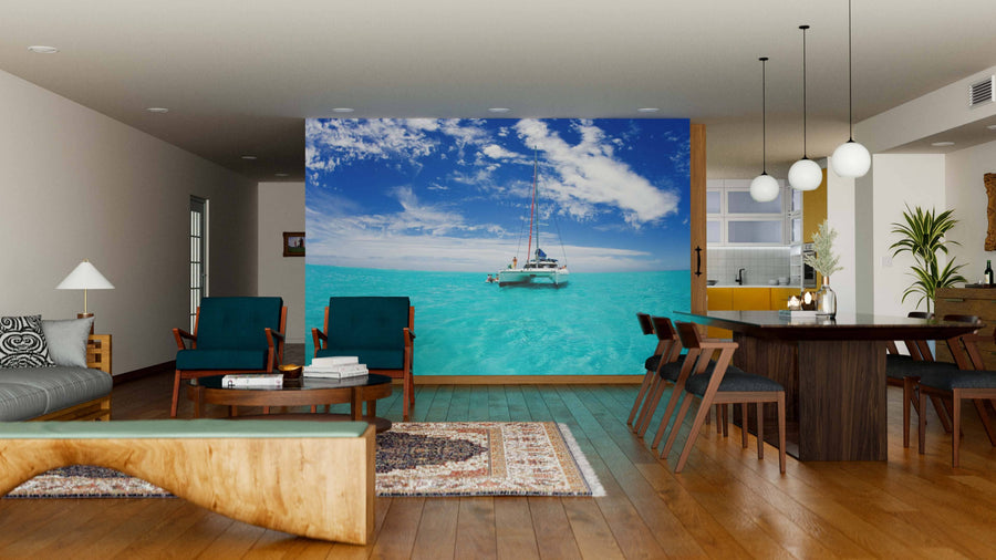 A modern living-dining room with wood floors and furniture features the Bora Bora Blue Lagoon Wall Mural on the back wall, depicting a catamaran on turquoise sea for an ocean view illusion in a bright, stylish, and contemporary space.