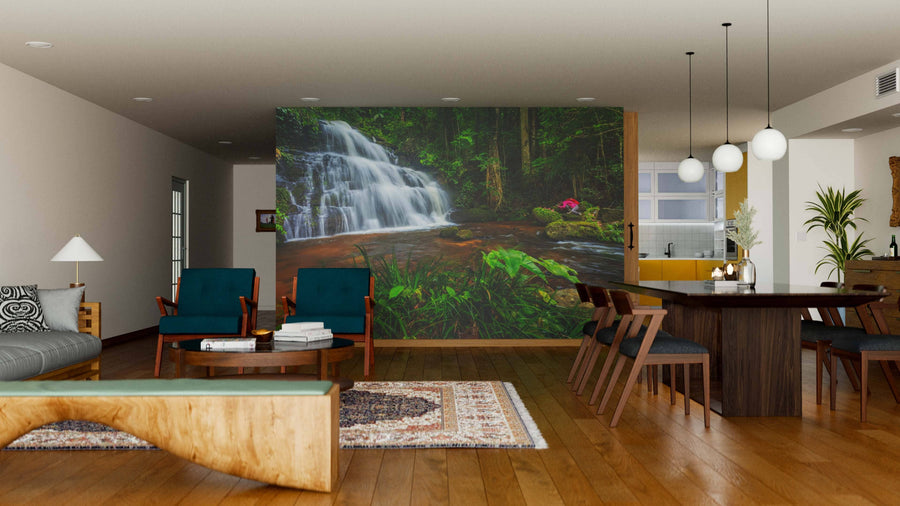 A modern open-concept living and dining room features wood floors, contemporary furniture, and the Breathtaking Waterfalls Wall Mural, bringing a natural, tranquil vibe to the stylish, well-lit interior.