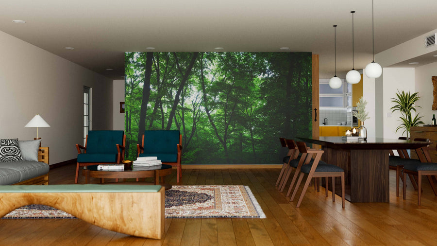 Modern living-dining room with wood floors, mid-century furniture, and pendant lights. The Forest Panorama Wall Mural adds a lush, natural ambiance. Area rugs, decorative accents, and plants complete this cozy, stylish space.