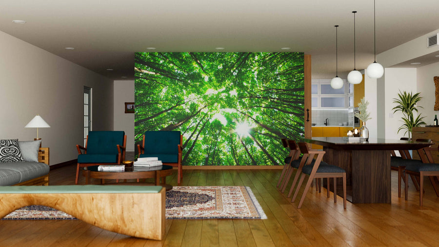 Modern open-plan living/dining area with wood floors and mid-century furniture, featuring the Green Forest Through the Canopy Wall Mural as a stunning focal point. Globe pendant lights illuminate a cozy seating area and dining table.