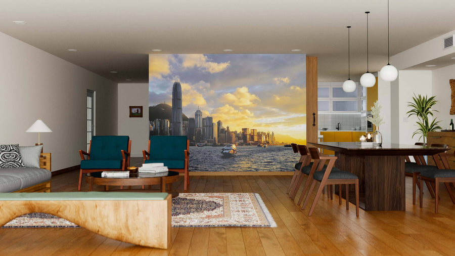 A modern living-dining room features wooden floors, blue chairs, stylish furniture, and a Hong Kong Sunrise Wall Mural, depicting a city skyline at dawn over water. A wooden dining table, rugs, and globe lights complete this inviting space.