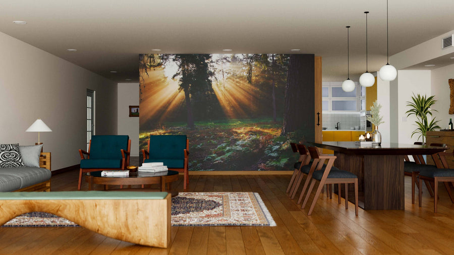 A modern living-dining room with wooden floors, teal chairs, a large dining table, pendant lights, and an Inspirational Dawn Wall Mural creates a warm, inviting vibe. Cozy mid-century furniture completes the open space.