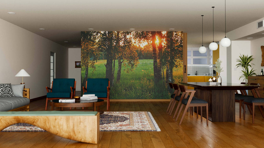 A modern open-plan living and dining room with wood floors, stylish furniture, and a striking Meadow with High Grass Wall Mural. Pendant lights hang over a dark wood table; yellow kitchen cabinets are visible in the background.