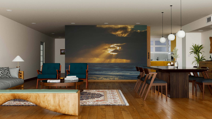 A modern open-concept living and dining area features wooden floors, mid-century furniture, and a stunning "Midnight Sun at Iceland" wall mural. Rugs and pendant lights add warmth, while the kitchen remains visible in the background.