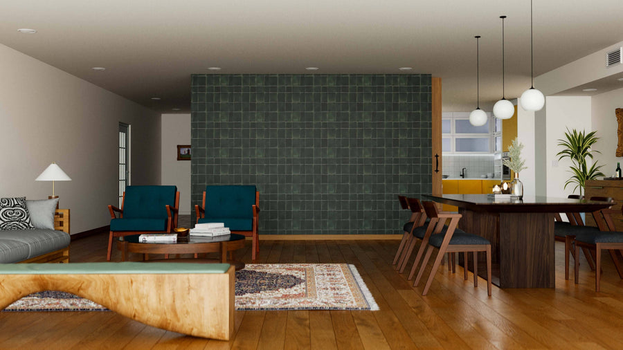 A modern living-dining room features wood floors, the Mystic Jade Wall Mural as a gray-tiled accent wall, teal armchairs, a gray sofa, and a dark wood dining table. Globe pendant lights, rugs, and plants add warmth to the space.