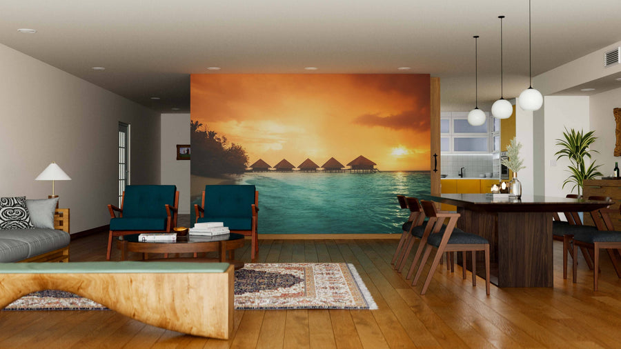 A modern open living-dining room with wooden floors and mid-century furniture features the Overwater Bungalows With Steps Wall Mural, a cozy sitting area, dining table with chairs, and globe pendant lights.