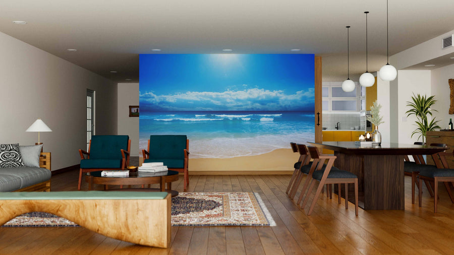 Modern open-plan living and dining area with wood floors, stylish furniture, a Paradise Beach Waves Wall Mural, dark wood dining table, pendant lights, and a cozy sitting area with armchairs and a bench.