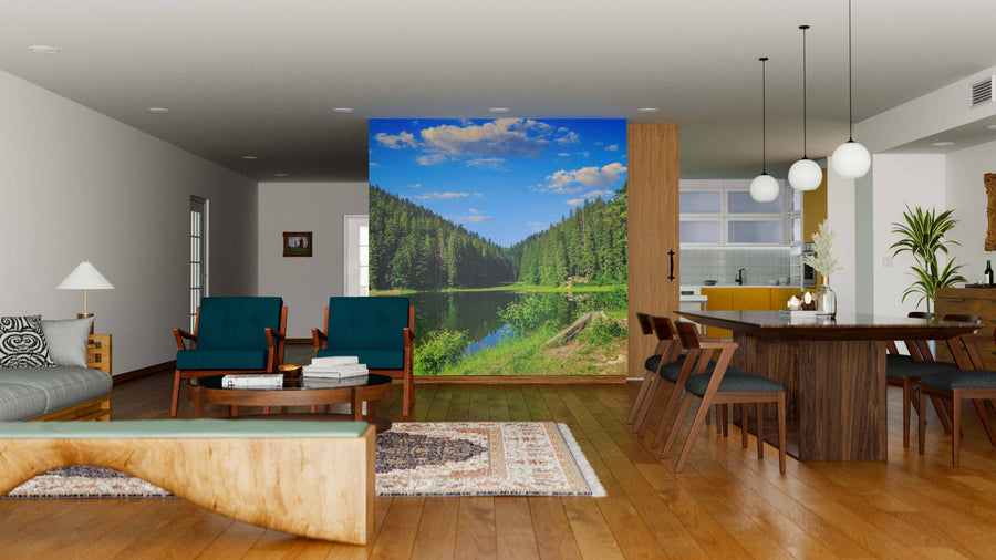 A modern living-dining room with wooden floors, green and wood furniture, rugs, pendant lights, and a striking large Pine Forest and Lake Wall Mural that brings a bright outdoors feel to the stylish interior.
