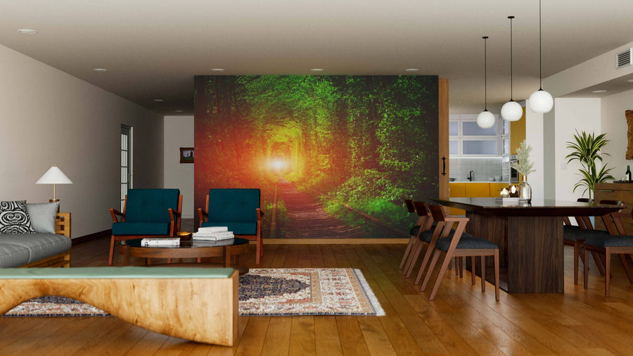 Modern open-concept living and dining area with wood floors and furniture. Behind the dining table, the "Railway in The Spring Forest Wall Mural" adds a sunlit forest scene. The room features contemporary lighting, area rugs, and green-upholstered chairs.