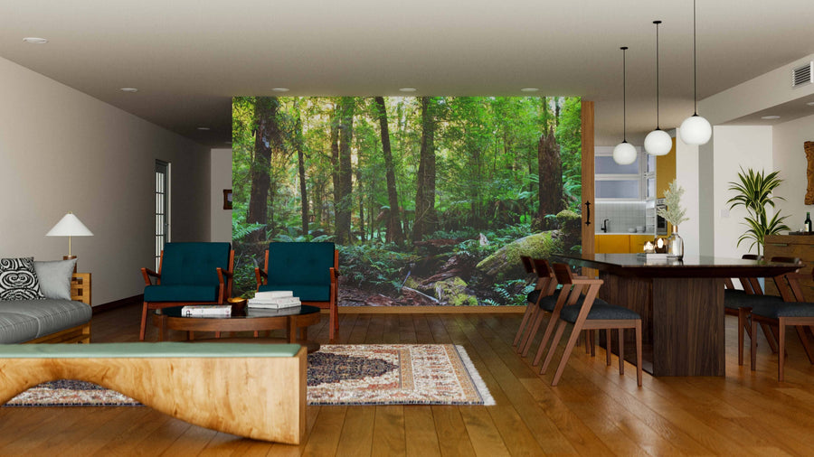 Modern open-plan living and dining room with wooden floors, eclectic furniture, and the Rainforest Panorama Wall Mural for a tranquil vibe. Stylish pendant lights and patterned rugs complete the look.